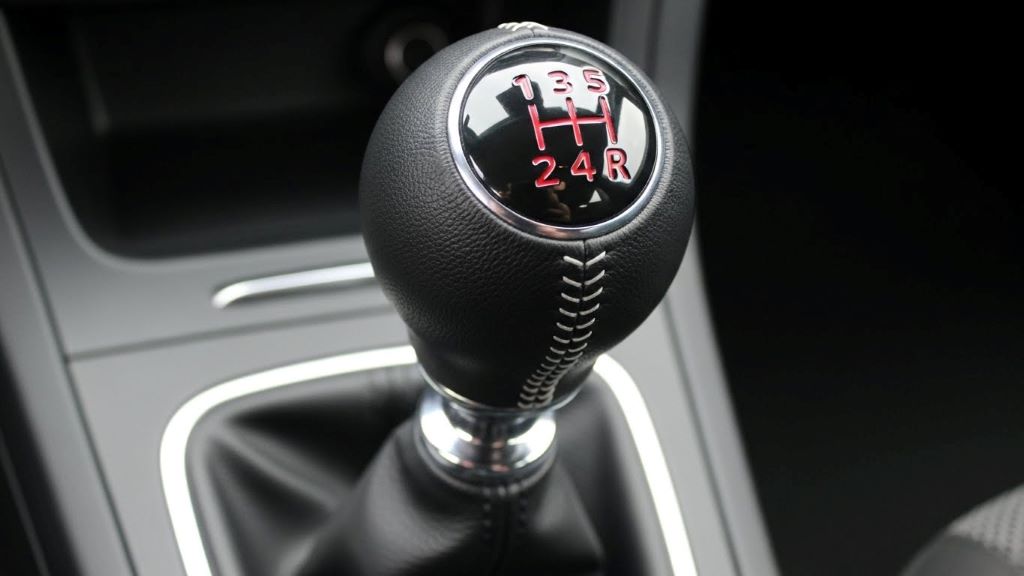 Close-up view of manual transmission gear shifter showing first and second gear positions